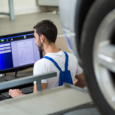 Werkstattmitarbeiter kalkuliert einen Unfallschaden mit SilverDAT 3 der Software für Fahrzeugbewertungen und Reparaturkostenkalkulationen